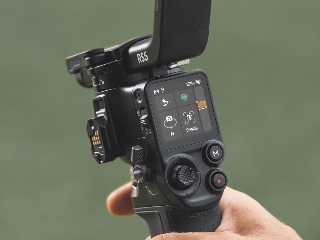 Close-up of controls on a DJI gimbal, against a green background