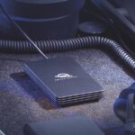 An SSD from Other World Computing with a wire attached, in a dark environment